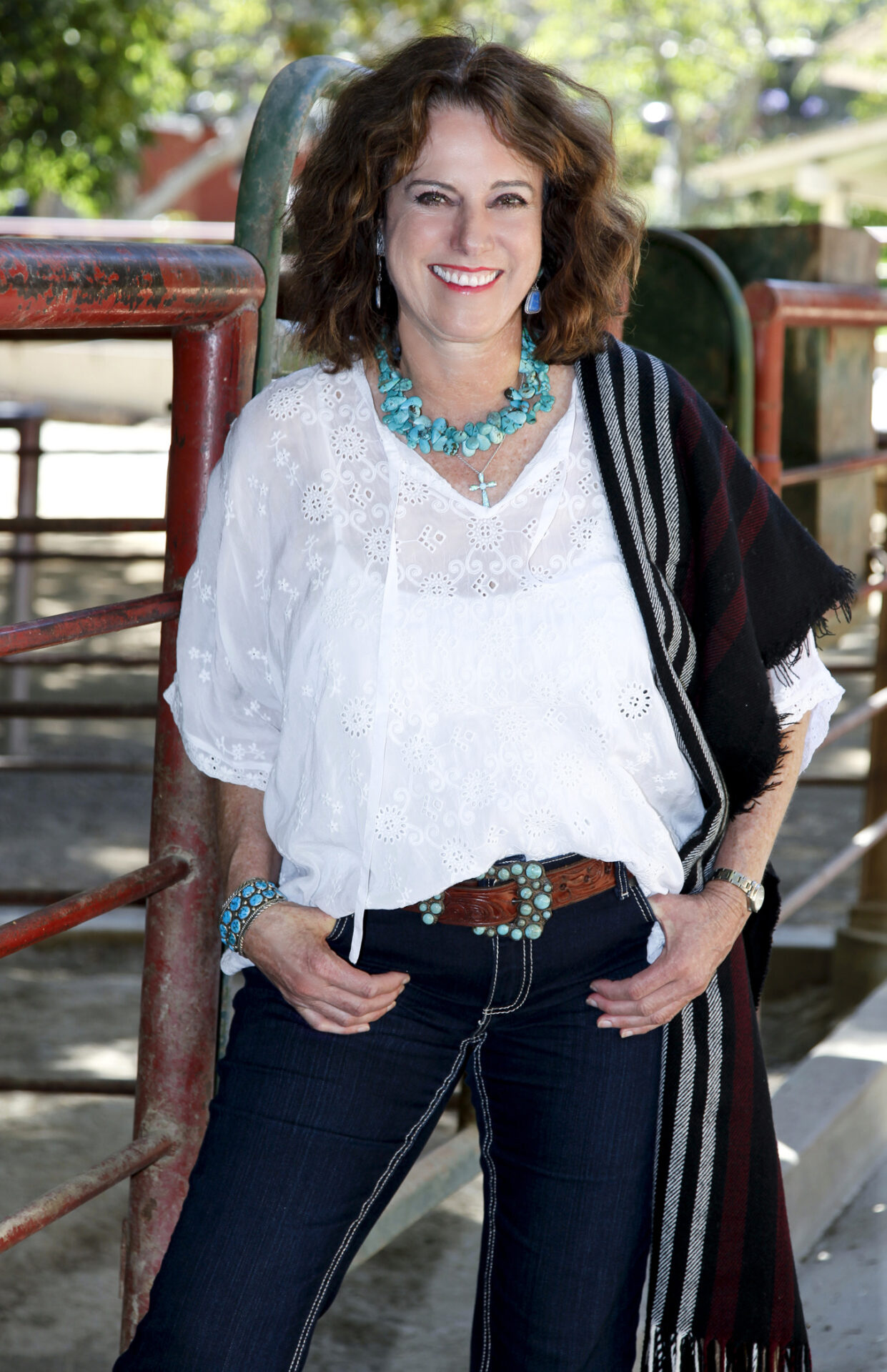 A woman wearing a white shirt and jeans.