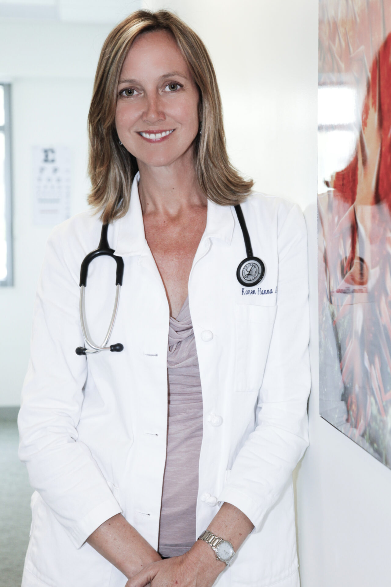 A woman wearing a white coat and a stethoscope.