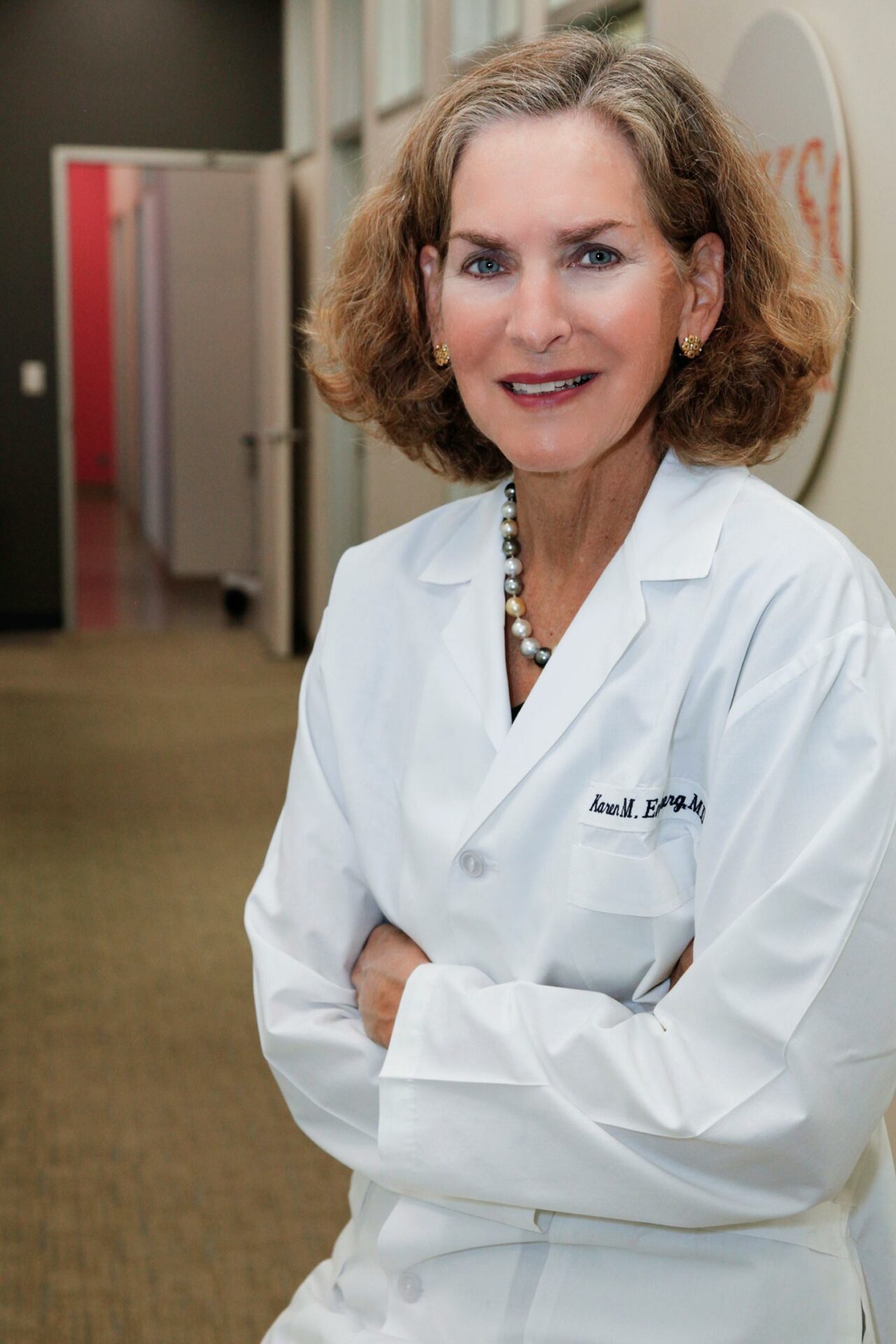 A woman in a lab coat posing for a photo.